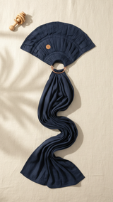Navy blue baby carrier with a ring on a beige background